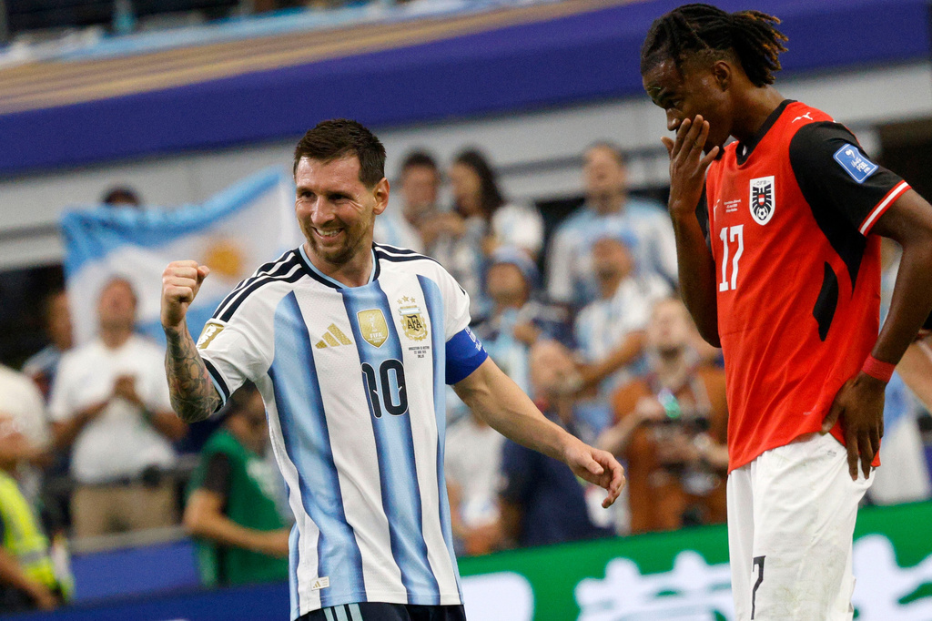 Argentina's Lionel Messi (10) celebrates scoring his second goal as Austria's Carney Chukwuemeka (17) looks down during the World Cup Group J soccer match between Argentina and Austria in Arlington, Texas, near Dallas, Monday, June 22, 2026. (Chitose Suzuki/The Dallas Morning News via AP)