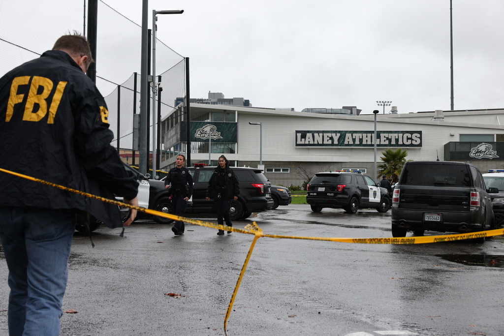 Law enforcement work the scene after a shooting at Laney College in Oakland, Calif., on Thursday, Nov. 13, 2025. (Santiago Mejia/San Francisco Chronicle via AP)
