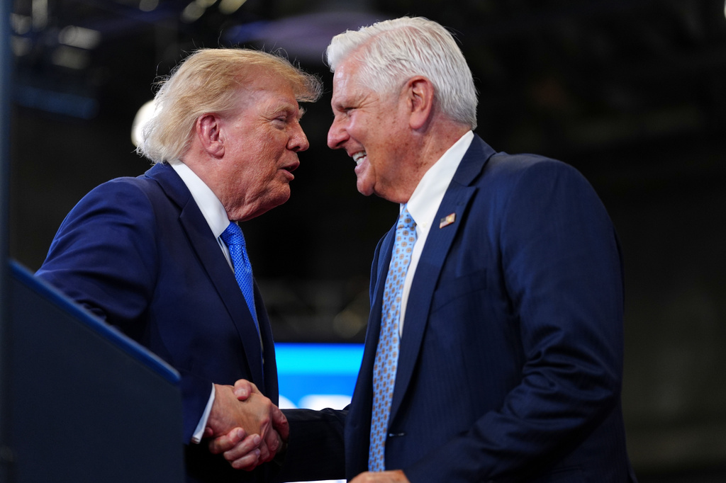 FILE - President Donald Trump, left, shakes the hand of Bruce Blakeman, the executive of Nassau County and Republican gubernatorial candidate for New York, during an event at the David Mack Center for Training and Intelligence, Aug. 14, 2026, in Garden City, N.Y. (AP Photo/Julia Demaree Nikhinson, File)