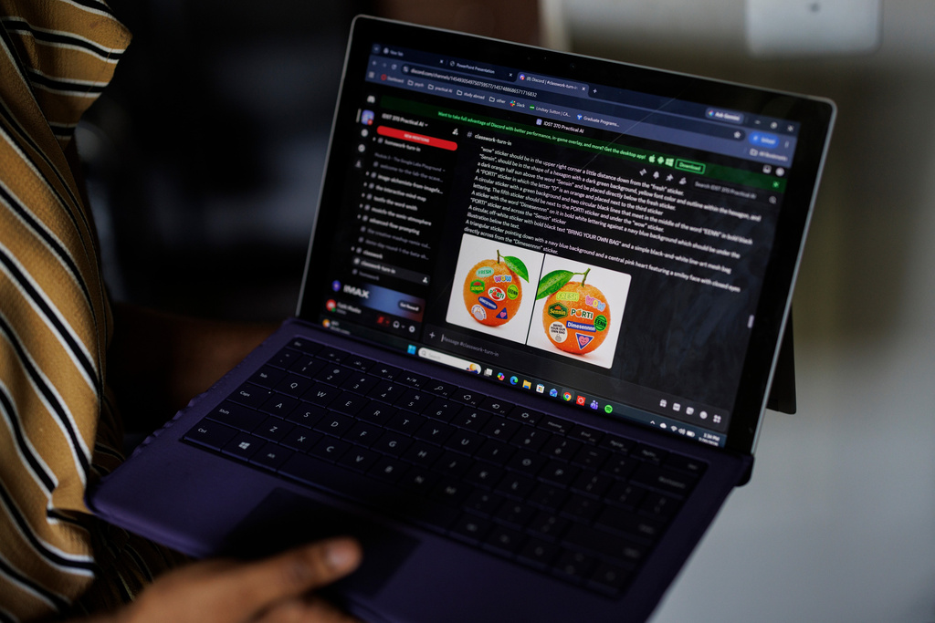 Faith Maeba, a student at Virginia Commonwealth University, shares an assignment she completed assignment for her Practical AI Synthesis course at her home, Monday, July 20, 2026, in Stafford, Va. (AP Photo/Moriah Ratner)