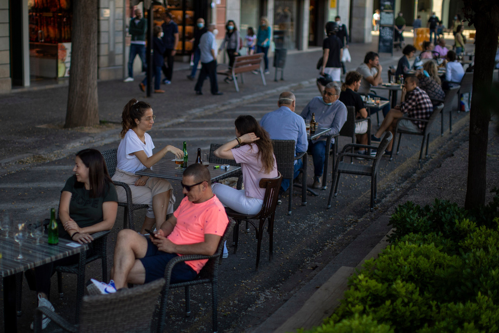 FILE - Customers sit at a terrace bar in Girona, Spain, on May 18, 2020. (AP Photo/Emilio Morenatti, File)