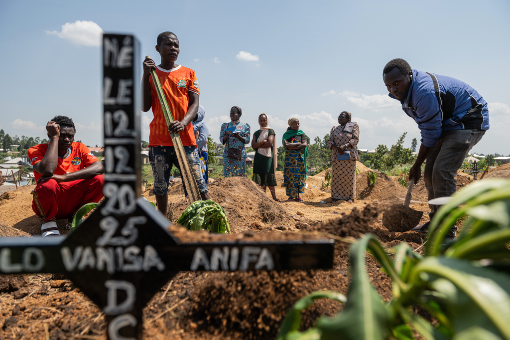 Relatives of Vanisa Anifa, a 6-month-old orphaned girl who died of Ebola, attend her burial, in Bunia, Congo, Friday, June 19, 2026. (AP Photo/Moses Sawasawa)