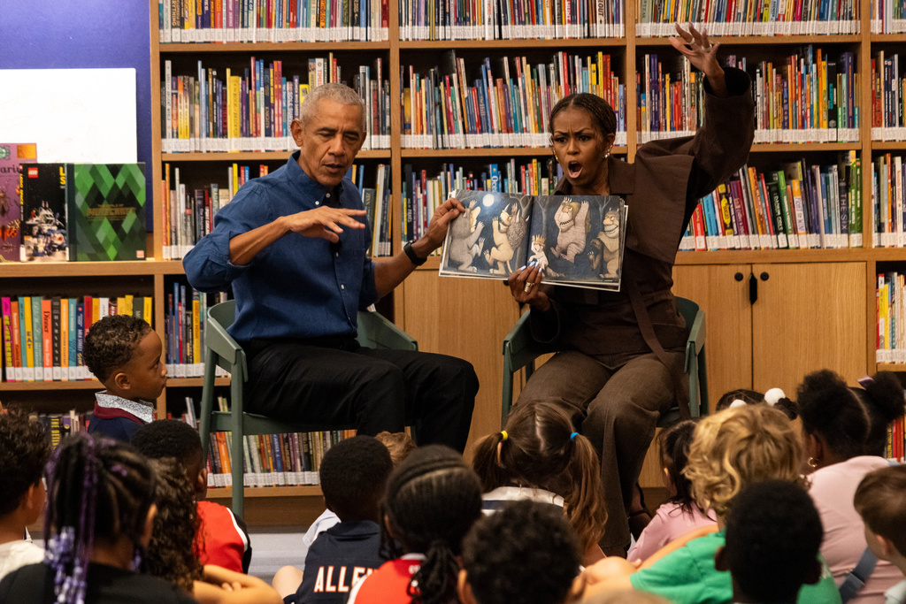 Former President Barack Obama and former first lady Michelle Obama read "Where the Wild Things Are" to students from William H. Ray Elementary School at the Obama Presidential Center's Chicago Public Library branch, Friday, June 19, 2026. (Ashlee Rezin /Chicago Sun-Times via AP, Pool)