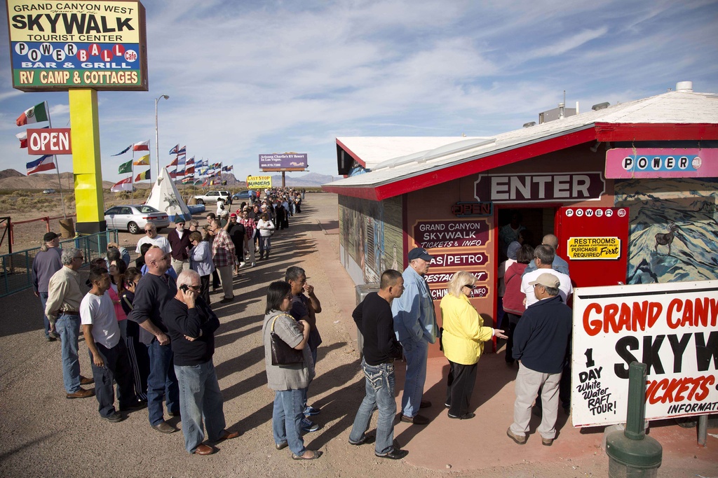 FILE - A crowd of people line up outside the Arizona Last Stop convenience store and souvenir shop to buy Powerball tickets, Tuesday, Nov. 27, 2012, in White Hills, Ariz. AP Photo/Julie Jacobson, File)