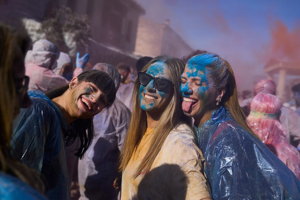Revelers take part in the annual flour war marking the end of the Carnival season on Clean Monday in Galaxidi, about 200 kilometers (120 miles) west of Athens, Feb. 23, 2026, starting the 40-day Christian Lent fast leading to Easter. (AP Photo/Petros Giannakouris)