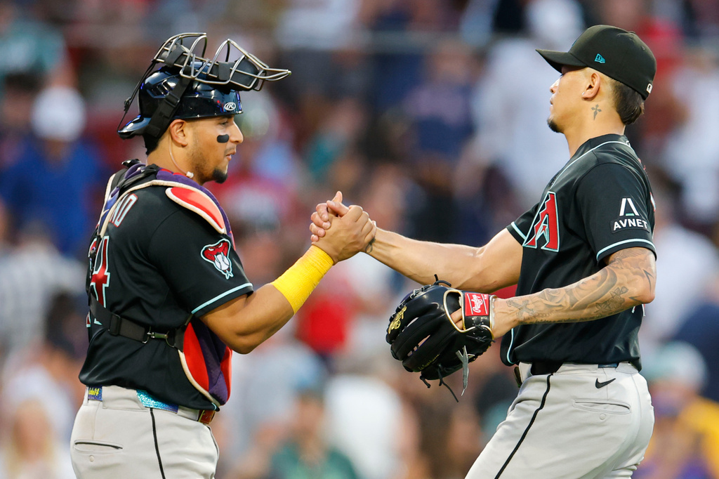 Arizona Diamondbacks catcher Gabriel Moreno congratulates pitcher' Jonathan Loáisiga following the win of a baseball game over the Boston Red Sox Wednesday, Aug. 19, 2026, in Boston. (AP Photo/CJ Gunther)