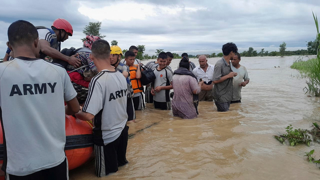 Nepalese army personnel transport survivors after a flood in Jhapa district east of Nepal, Sunday, Oct. 5, 2025. (Nepal Army via AP)
