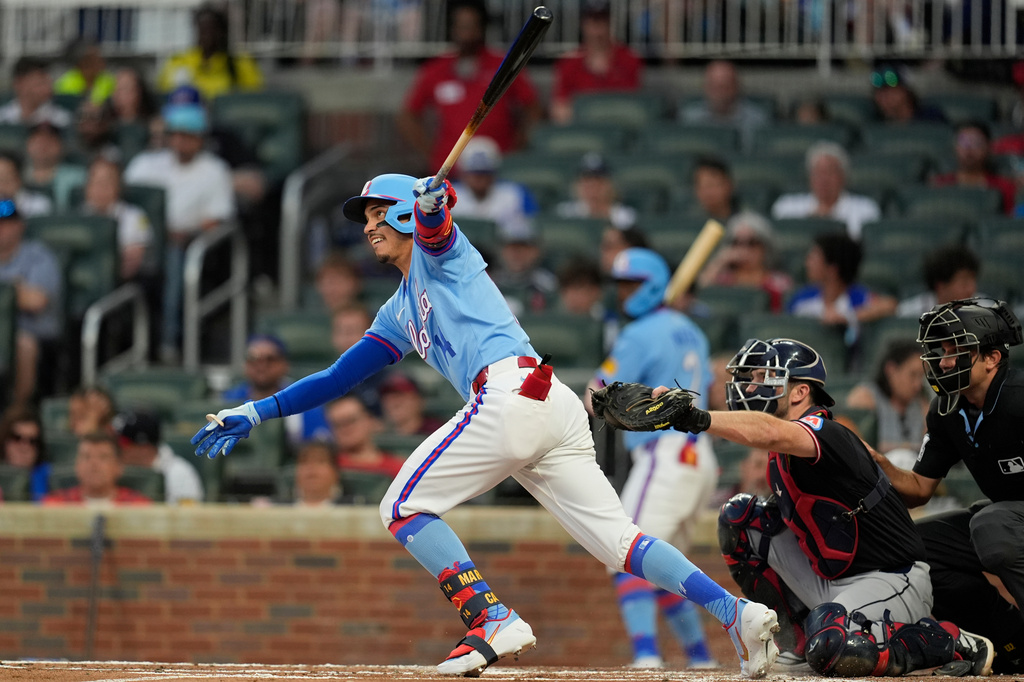 Atlanta Braves' Mauricio Dubón (14) hits an RBI-double against the Cleveland Guardians int her second inning of a baseball game, Sunday, April 12, 2026, in Atlanta. (AP Photo/Mike Stewart)