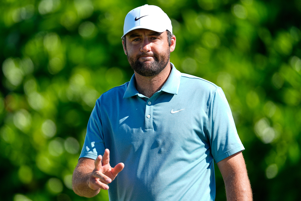 Scottie Scheffler, of the United States, reacts to making a birdie on the fourth hole during the third round of the Hero World Challenge PGA Tour at the Albany Golf Club, in New Providence, Bahamas, Saturday, Dec. 6, 2025. (AP Photo/Fernando Llano)