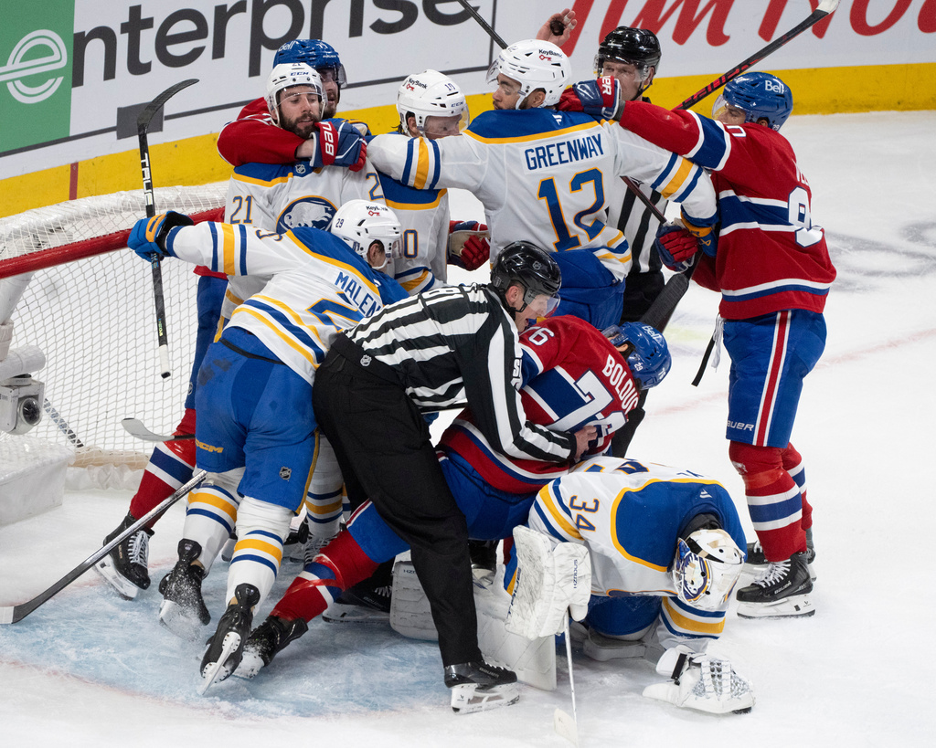 Montreal Canadiens and Buffalo Sabres scuffle in the crease behind Buffalo Sabres goaltender Alex Lyon (34) during the first period of Game 3 in a second-round NHL hockey Stanley Cup playoff series in Montreal, Sunday, May 10, 2026. (Christinne Muschi/The Canadian Press via AP)