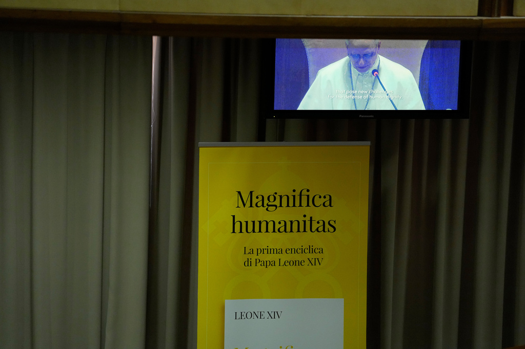 Pope Leo XIV, left, attends the presentation of his first encyclical, "Magnifica humanitas: On Safeguarding the Human Person in the Time of Artificial Intelligence," at the Vatican, Monday, May 25, 2026. (AP Photo/Alessandra Tarantino)