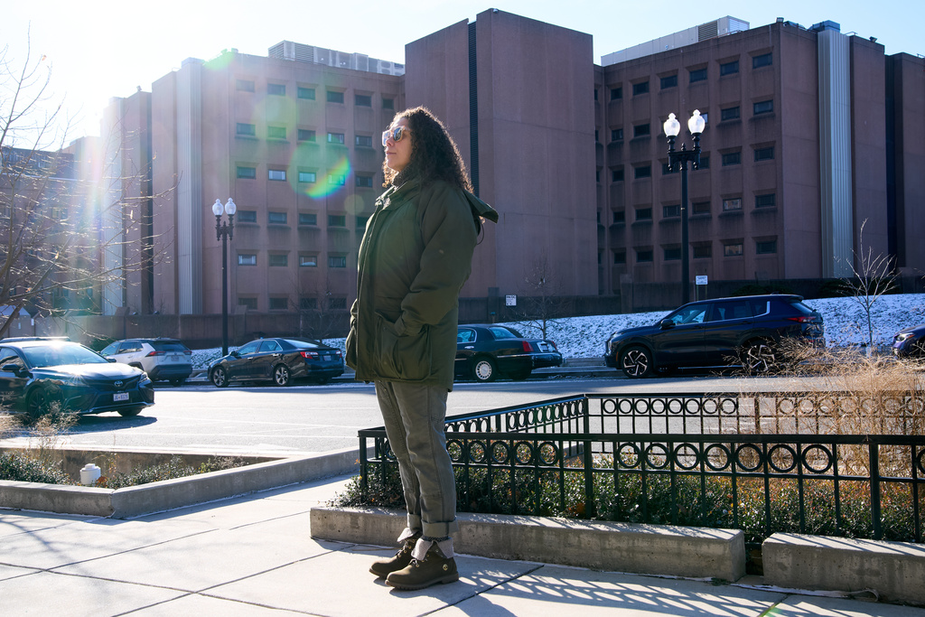 Sidney Reid, 44, of Washington, poses for a portrait near where she was arrested while protesting immigration detentions, Tuesday, Dec. 16, 2025, in Washington. (AP Photo/Jacquelyn Martin)