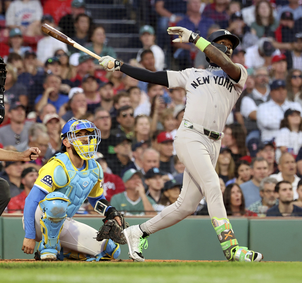 New York Yankees' Jazz Chisholm Jr., right, watches his home run during the fifth inning of a baseball game against the Boston Red Sox, Saturday, Sept. 13, 2025, in Boston. (AP Photo/Mark Stockwell)
