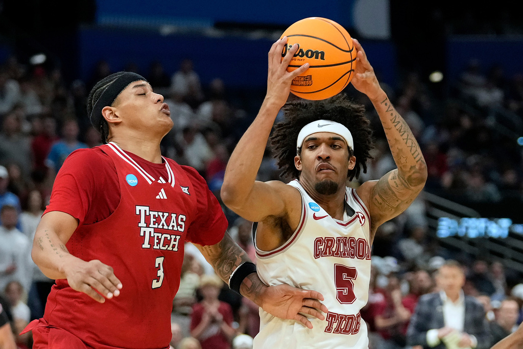 Alabama forward Amari Allen (5) drives against Texas Tech forward Lejuan Watts (3) during the first half in the second round of the NCAA college basketball tournament Sunday, March 22, 2026, in Tampa, Fla. (AP Photo/Chris O'Meara)