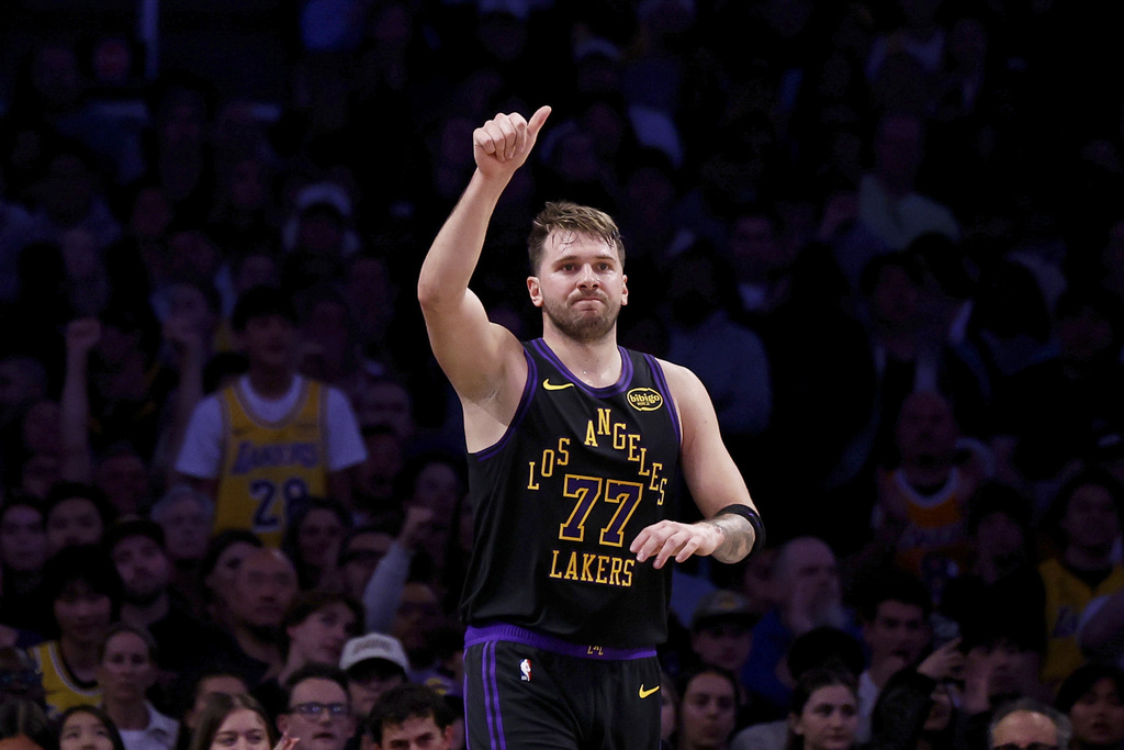 Los Angeles Lakers guard Luka Doncic (77) reacts after scoring during the first half of an NBA basketball game against the Detroit Pistons, Tuesday, Dec. 30, 2025, in Los Angeles. (AP Photo/Caroline Brehman)
