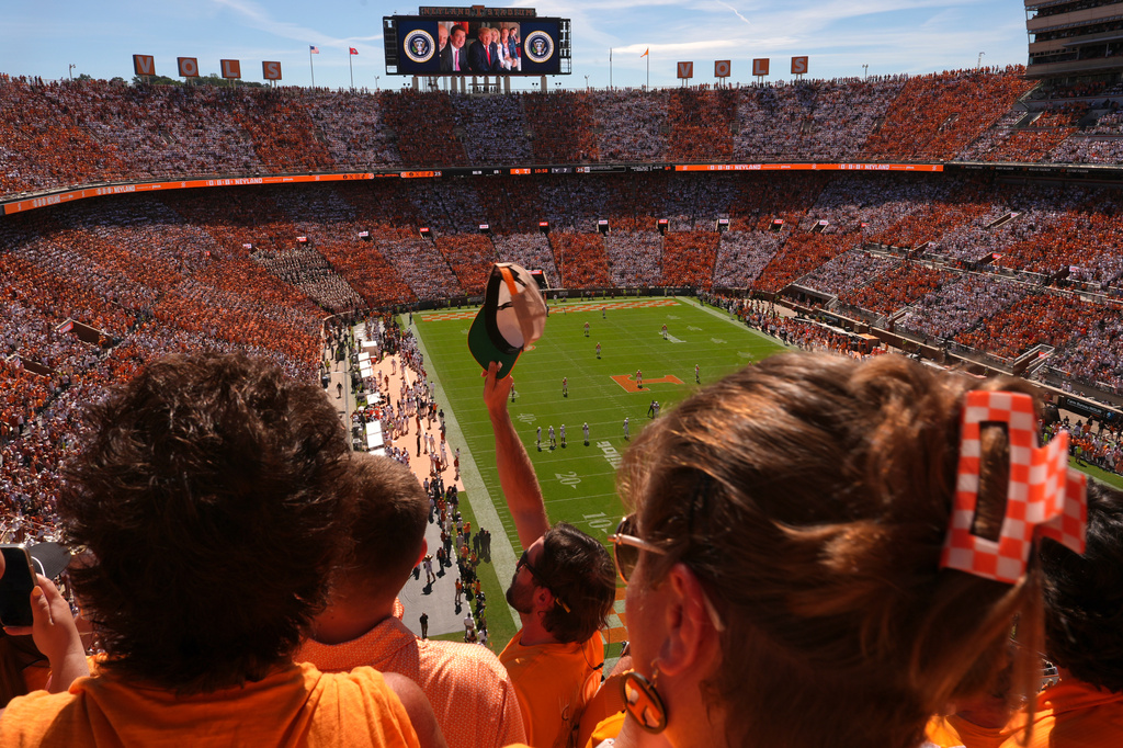 Attendees cheer as President Donald Trump is pictured on screen during an NCAA college football game between Tennessee and Texas at Neyland Stadium, Saturday, Sept. 26, 2026, in Knoxville, Tenn. (AP Photo/Julia Demaree Nikhinson)