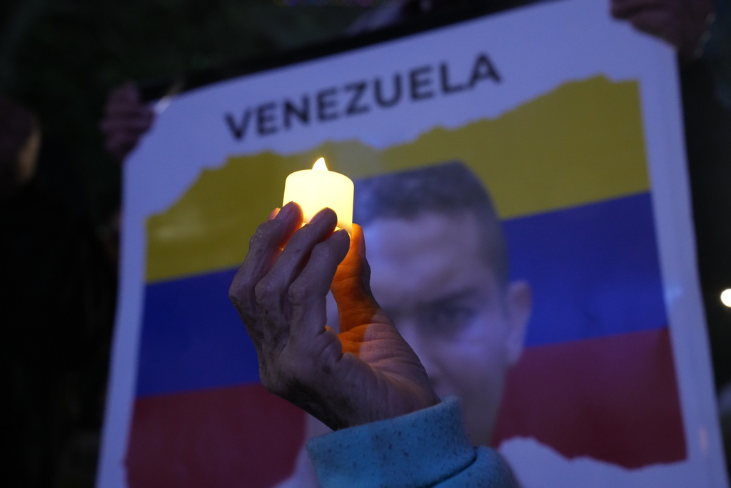 A Venezuelan opposition member holds up a candle during a demonstration ahead of the Nobel Peace Prize ceremony where Venezuelan Maria Corina Machado is among this year's laureates, in Mexico City, Saturday, Dec. 6, 2025. (AP Photo/Marco Ugarte)