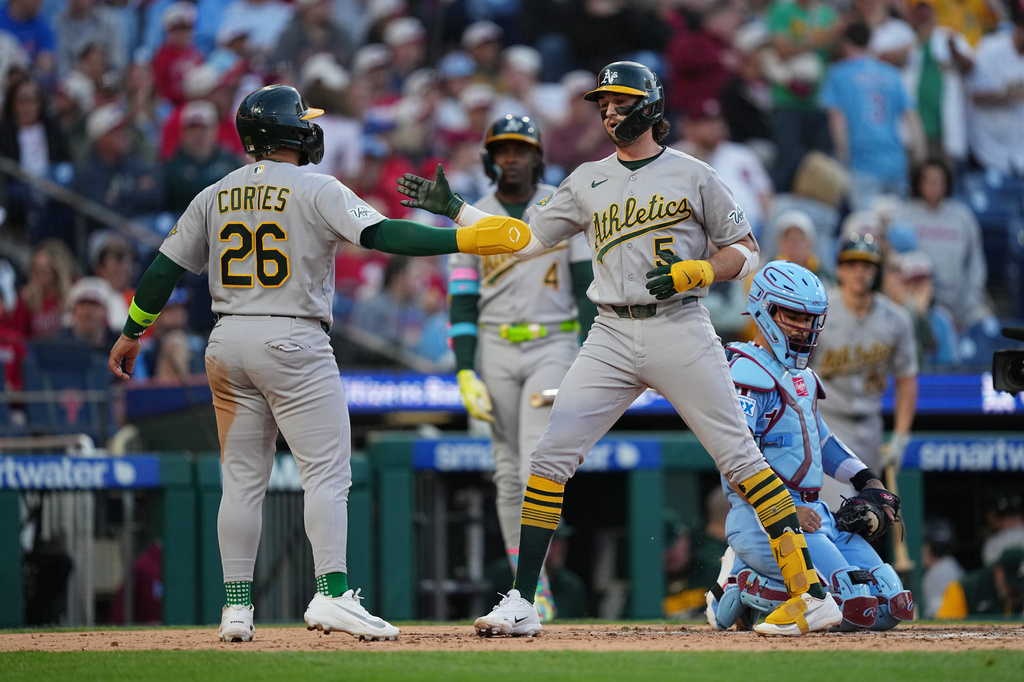 Athletics' Jacob Wilson, right, celebrates his two-run home run off of Philadelphia Phillies pitcher Andrew Painter with Carlos Cortes (26) during the third inning of a baseball game, Thursday, May 7, 2026, in Philadelphia. (AP Photo/Matt Rourke)