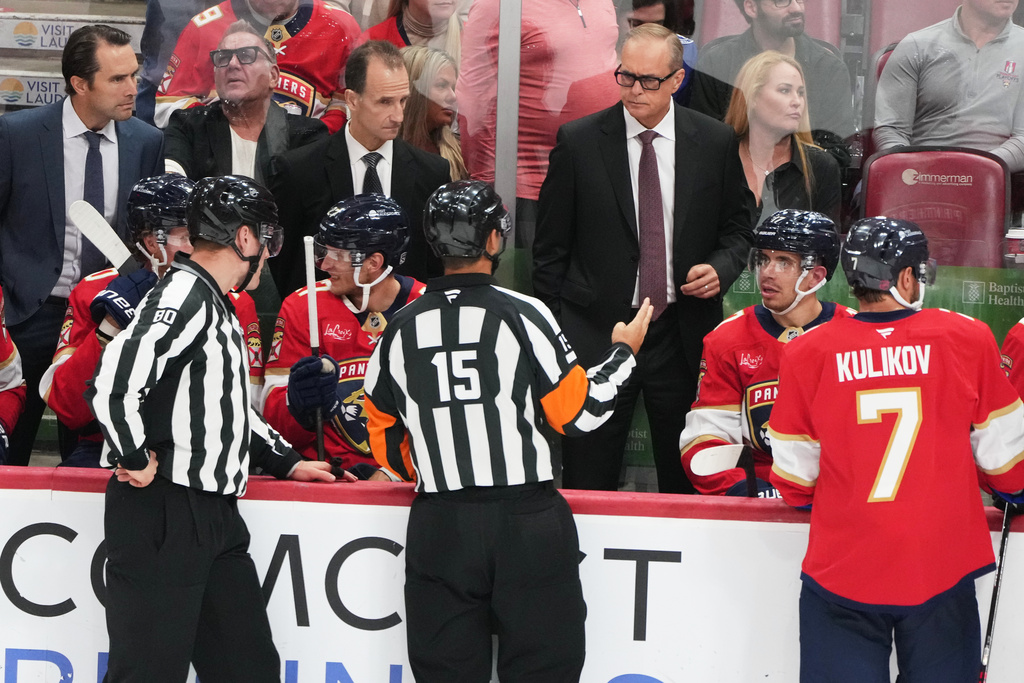 FIE - Florida Panthers head coach Paul Maurice, second from right, talks with officials during the third period of a preseason NHL hockey game against the Tampa Bay Lightning, Saturday, Oct. 4, 2025, in Sunrise, Fla. (AP Photo/Lynne Sladky, File)