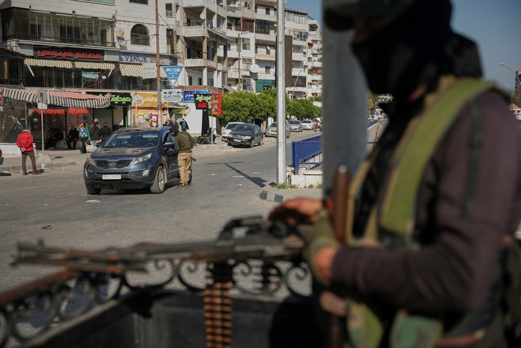 FILE- Syrian security forces inspect vehicles at a checkpoint, following a recent wave of violence between Syrian security forces and gunmen loyal to former President Bashar Assad, as well as subsequent sectarian attacks, in Latakia, in Syria's coastal region, March 11, 2025. (AP Photo/Ghaith Alsayed, File)