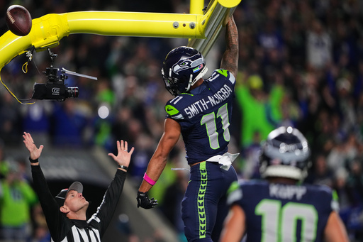 Seattle Seahawks wide receiver Jaxon Smith-Njigba (11) celebrates his touchdown catch as an official signals and looks on in the first half of an NFL football game Monday, Oct. 20, 2025, in Seattle. (AP Photo/Lindsey Wasson) Seattle Seahawks wide receiver Jaxon Smith-Njigba (11) celebrates his touchdown catch as an official signals and looks on in the first half of an NFL football game Monday, Oct. 20, 2025, in Seattle. (AP Photo/Lindsey Wasson)