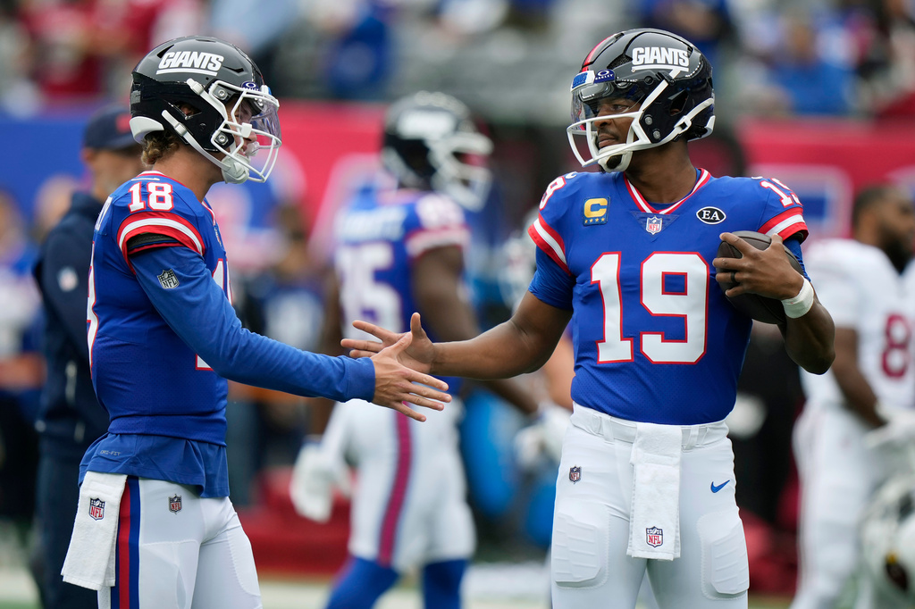 New York Giants quarterback Jameis Winston (19) shakes hands with Giants quarterback J.J. McCarthy (18) prior to an NFL football game against the Arizona Cardinals, in East Rutherford, N.J., Sunday, Oct. 4, 2026. (AP Photo/Seth Wenig)
