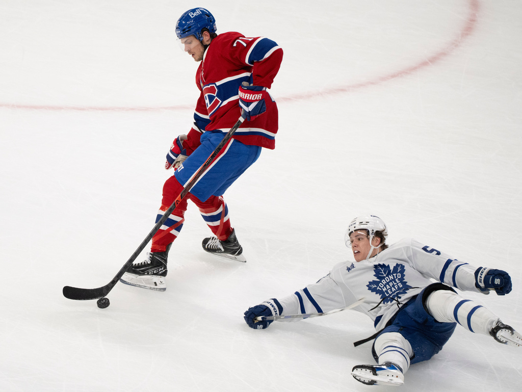 Montreal Canadiens' Jake Evans (71) gets past Toronto Maple Leafs' Easton Cowan (53) for an empty net goal during third period NHL hockey action in Montreal on Tuesday, March 10, 2026. (Christinne Muschi/The Canadian Press via AP)