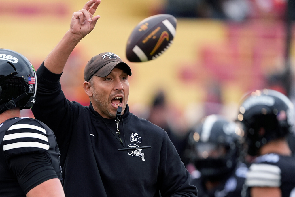 FILE - Iowa State head coach Matt Campbell, center, directs his team during warm ups before an NCAA college football game against BYU, Saturday, Oct. 25, 2025, in Ames, Iowa. (AP Photo/Matthew Putney, File)
