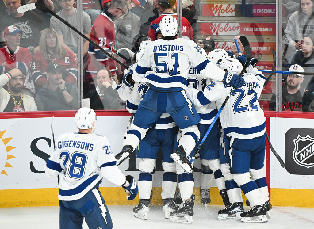Tampa Bay Lightning players celebrate after a goal by teammate Gage Goncalves (partially obscured) during overtime of Game 6 in the first round of an NHL hockey Stanley Cup playoff series against the Montreal Canadiens in Montreal, Friday, May 1, 2026. (Graham Hughes/The Canadian Press via AP)