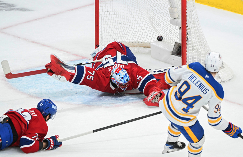 Buffalo Sabres' Konsta Helenius (94) scores against Montreal Canadiens goaltender Jakub Dobes (75) as Canadiens' Arber Xhekaj (72) defends during the second period of Game 6 in a second-round NHL hockey Stanley Cup playoff series in Montreal, Saturday, May 16, 2026. (Graham Hughes/The Canadian Press via AP)