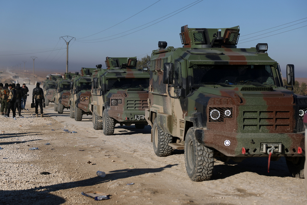 Syrian government forces in armored vehicles enter the al-Hol camp in northeastern Syria's Hasakeh province, Syria, Wednesday, Jan. 21, 2026, after the withdrawal of the Syrian Democratic Forces (SDF). (AP Photo/Ghaith Alsayed)