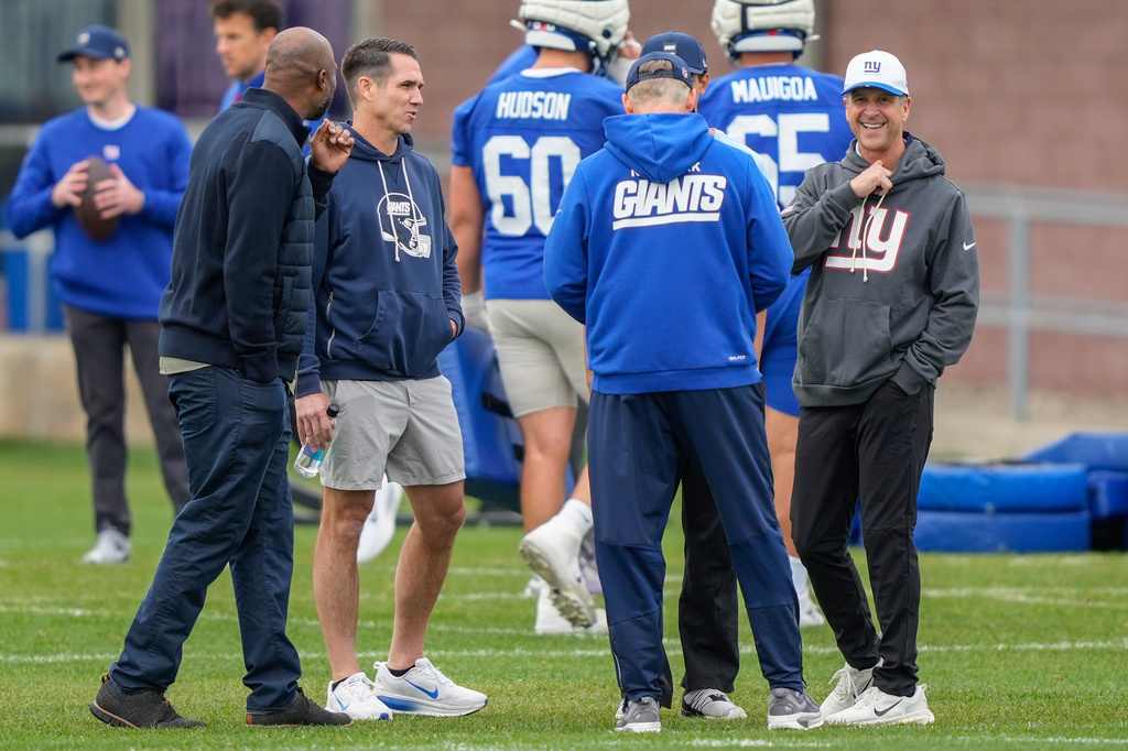 New York Giants head coach John Harbaugh, right, and New York Giants general manager Joe Schoen, second left, talk during the rookie minicamp at the NFL football team's practice facility, Saturday, May 9, 2026, in East Rutherford, N.J. (AP Photo/Yuki Iwamura)