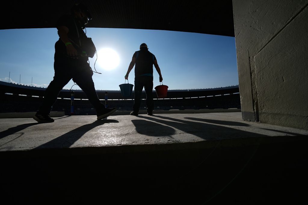 Workers renovate the Azteca Stadium during a press tour ahead of the 2026 World Cup, in Mexico City, Thursday, March 26, 2026. (AP Photo/Marco Ugarte)
