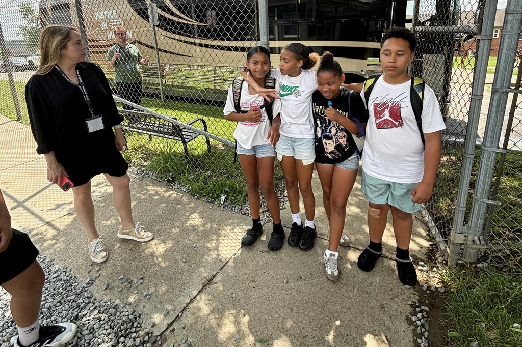 Students at The LeMoyne Community Center in Washington, Pa., pose for a photo Tuesday, July 7, 2026, in front of a tour bus carrying retired judges on a tour through the Rust Belt to defend judicial independence. (Keep Our Republic via AP)