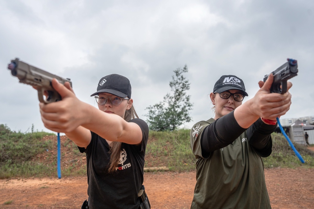 Mother and daughter Ninieve and Isabella Du Plessis, train at the Out There Sport Shooting Range in Bronkhorstspruit, Pretoria, South Africa, Saturday, Jan. 24, 2026. (AP Photo/Jacques Nelles)