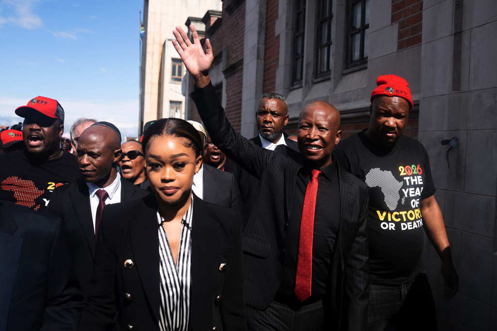 Julius Malema, Economic Freedom Fighters (EFF) party leader, waves to supporters after he was sentenced to prison for firing a rifle at a political rally, in East London, South Africa, Thursday, April 16, 2026. (AP Photo)