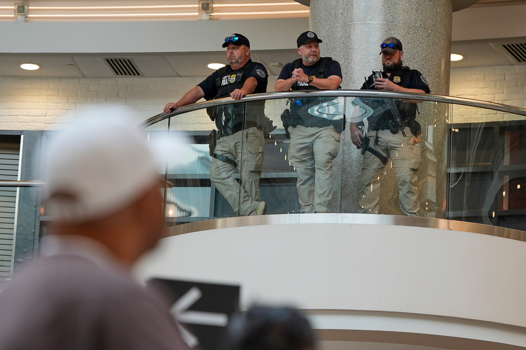 Federal immigration agents are seen at the Hartsfield-Jackson Atlanta International Airport, Monday, March 23, 2026, in Atlanta. (AP Photo/Mike Stewart)