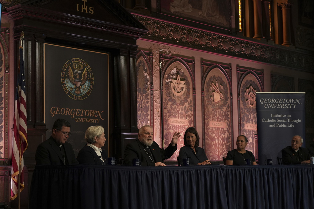 The archbishop of Miami, Thomas Wenski, raises his hand while addressing a crowd during a panel on immigration at Georgetown University in Washington, Thursday, Sept. 11, 2025. (AP Photo/Luis Andres Henao)