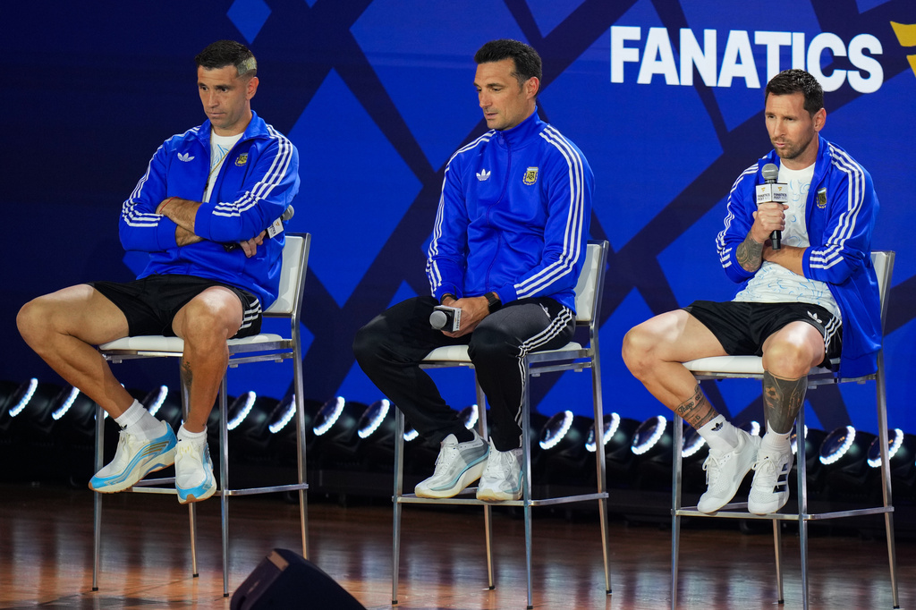 From left, Argentina goalkeeper Emiliano Martinez and head coach Lionel Scaloni listen as Lionel Messi speaks during a news conference ahead of the World Cup final soccer match between Spain and Argentina in New York, Friday, July 17, 2026. (AP Photo/Stephanie Scarbrough)