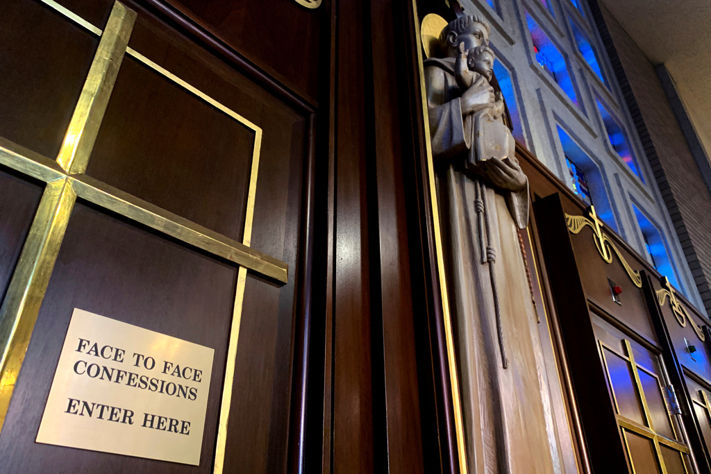 FILE - Gold crosses and statues adorn confessional rooms at St. Michael Archangel Catholic Church in Houston, on April 13, 2019. (AP Photo/Wong Maye-E, File)