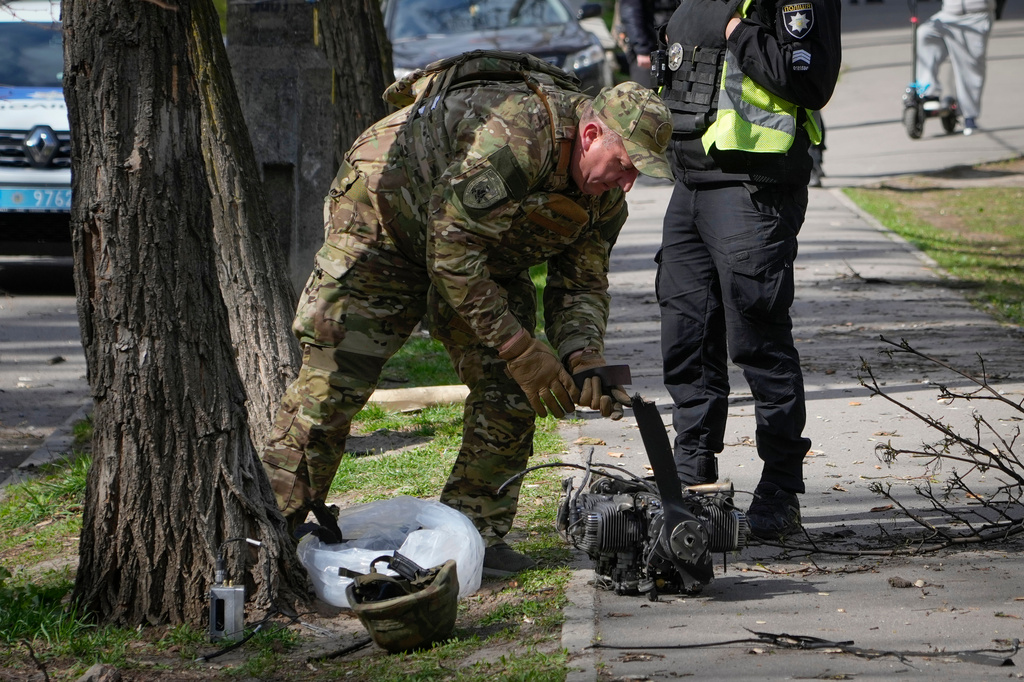 Police officers inspect fragments of a Russian drone after an air attack in Kyiv, Ukraine, Tuesday, April 28, 2026. (AP Photo/Efrem Lukatsky)