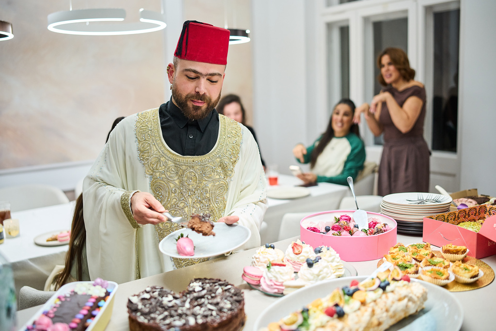 Haidar Darwish, a belly dancer and artist who came from Syria, attends an inclusive Iftar, the Ramadan fast-breaking meal, with friends who are Muslim, Christian, queer and straight, in Berlin, Germany, Wednesday, March 11, 2026. (AP Photo/Ebrahim Noroozi)