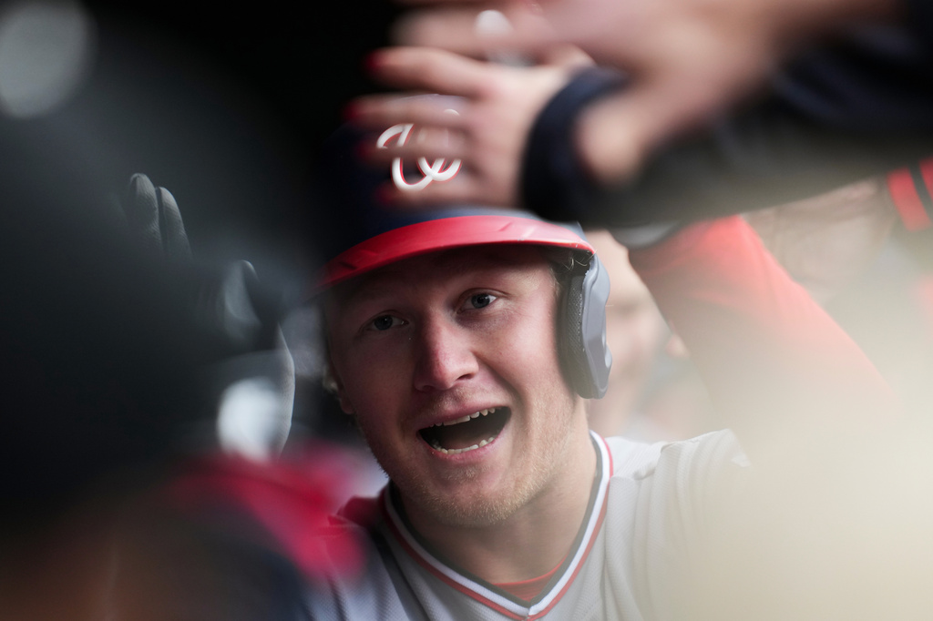 Washington Nationals' Joey Wiemer (21) is greeted in the dugout after hitting a home run during the second inning of an opening-day baseball game against the Chicago Cubs, Thursday, March 26, 2026, in Chicago. (AP Photo/Erin Hooley)