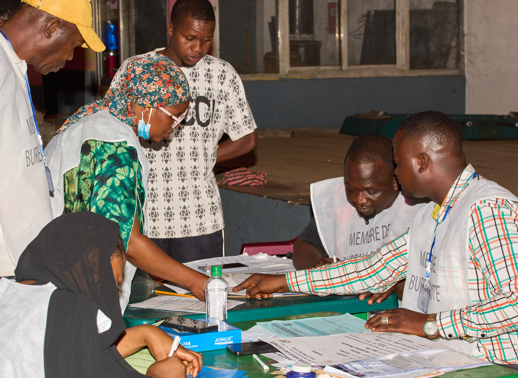 Officials count ballots at a polling station as polls close during the presidential election in Conakry, Guinea, Sunday, Dec. 28, 2025. (AP Photo/Fode Toure)