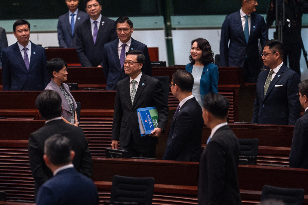 Hong Kong's Chief Executive John Lee, center, arrives at the Legislative Council to delivers the first Five-Year Plan and policy address in Hong Kong, Wednesday, Sept. 16, 2026. (AP Photo/Chan Long Hei)