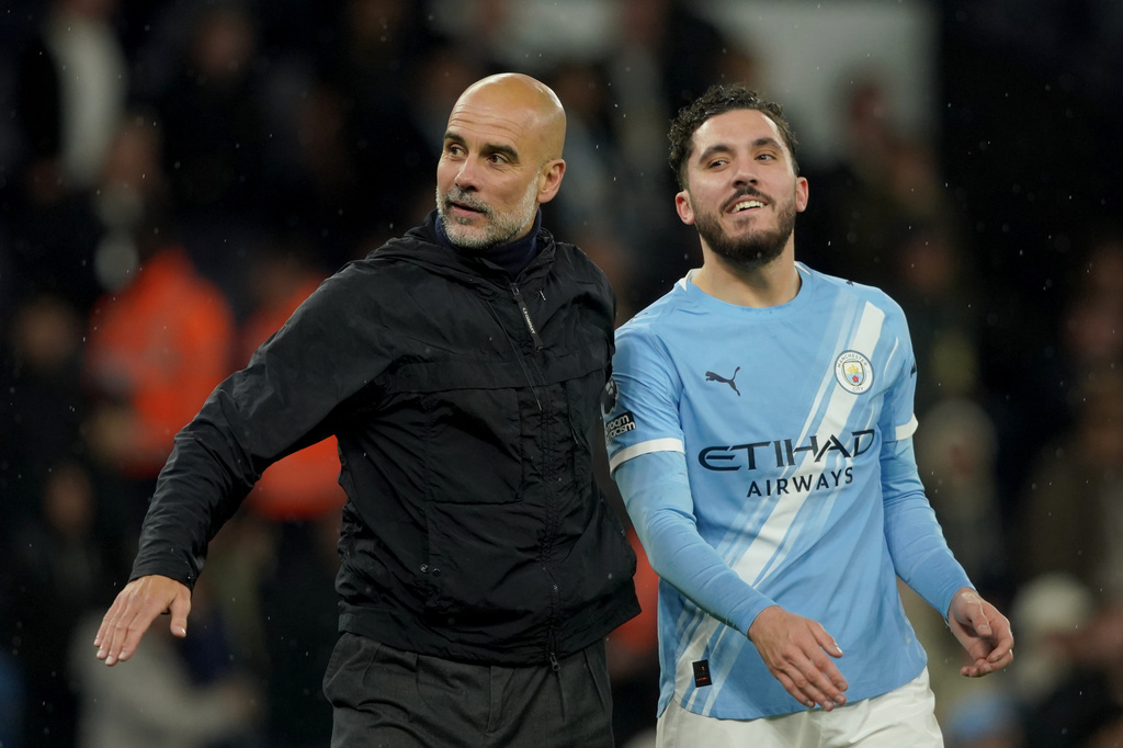Manchester City's head coach Pep Guardiola, left, celebrates with Manchester City's Rayan Cherki at the end of the English Premier League soccer match between Manchester City and Crystal Palace in Manchester, England, Wednesday, May 13, 2026. (AP Photo/Ian Hodgson)