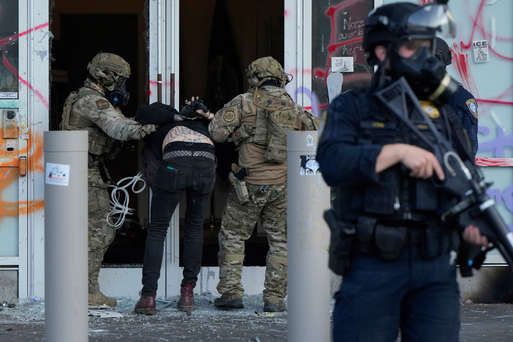 FILE - U.S. Customs and Border Protection agents detain a man outside the U.S. Immigration and Customs building during a protest in Portland, Ore., June 14, 2025. (AP Photo/Jenny Kane, File)
