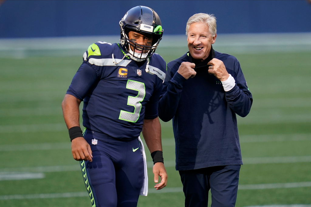FILE - Seattle Seahawks quarterback Russell Wilson (3) talks with head coach Pete Carroll before an NFL football game against the New England Patriots, Sept. 20, 2020, in Seattle. (AP Photo/Elaine Thompson, File)