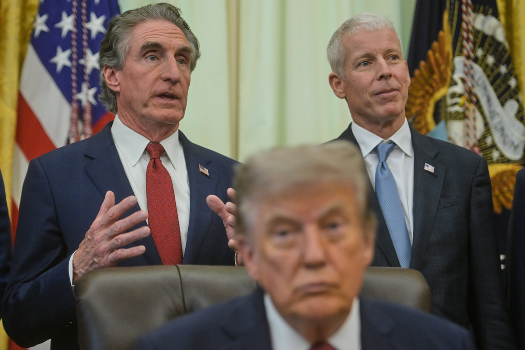 President Donald Trump and Energy Secretary Chris Wright listen as Interior Secretary Doug Burgum speaks in the Oval Office of the White House, Friday, July 24, 2026, in Washington. (AP Photo/Rod Lamkey, Jr.)
