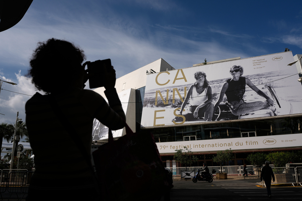 A person takes a photo outside the Palais des Festivals during preparations for the 79th international film festival, Cannes, southern France, Monday, May 11, 2026. (AP Photo/John Locher)